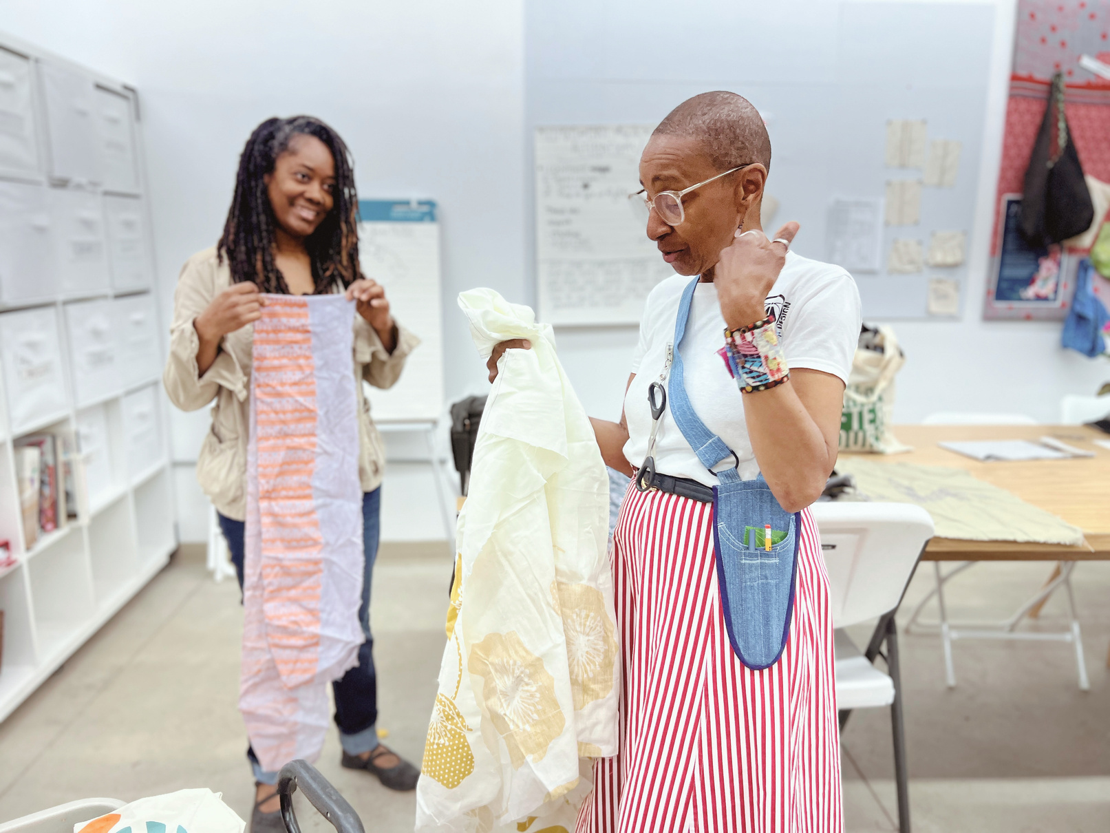 D'Artillery and Scarlet Crane founders reviewing fabric in the studio