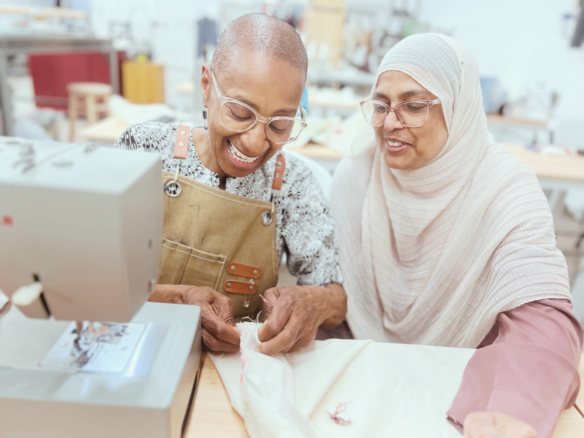 Two makers working together at a sewing machine